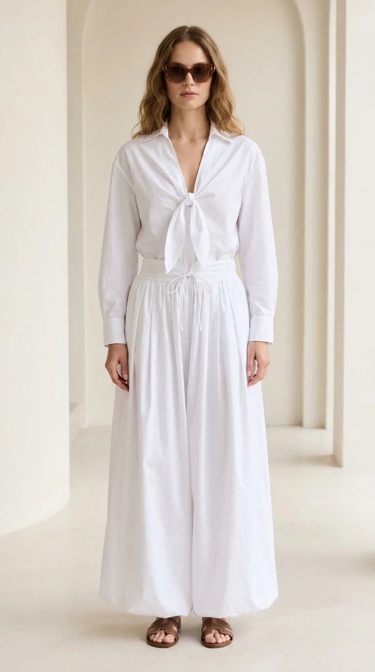 Woman wearing white tie-front shirt and wide-leg pants set, front view