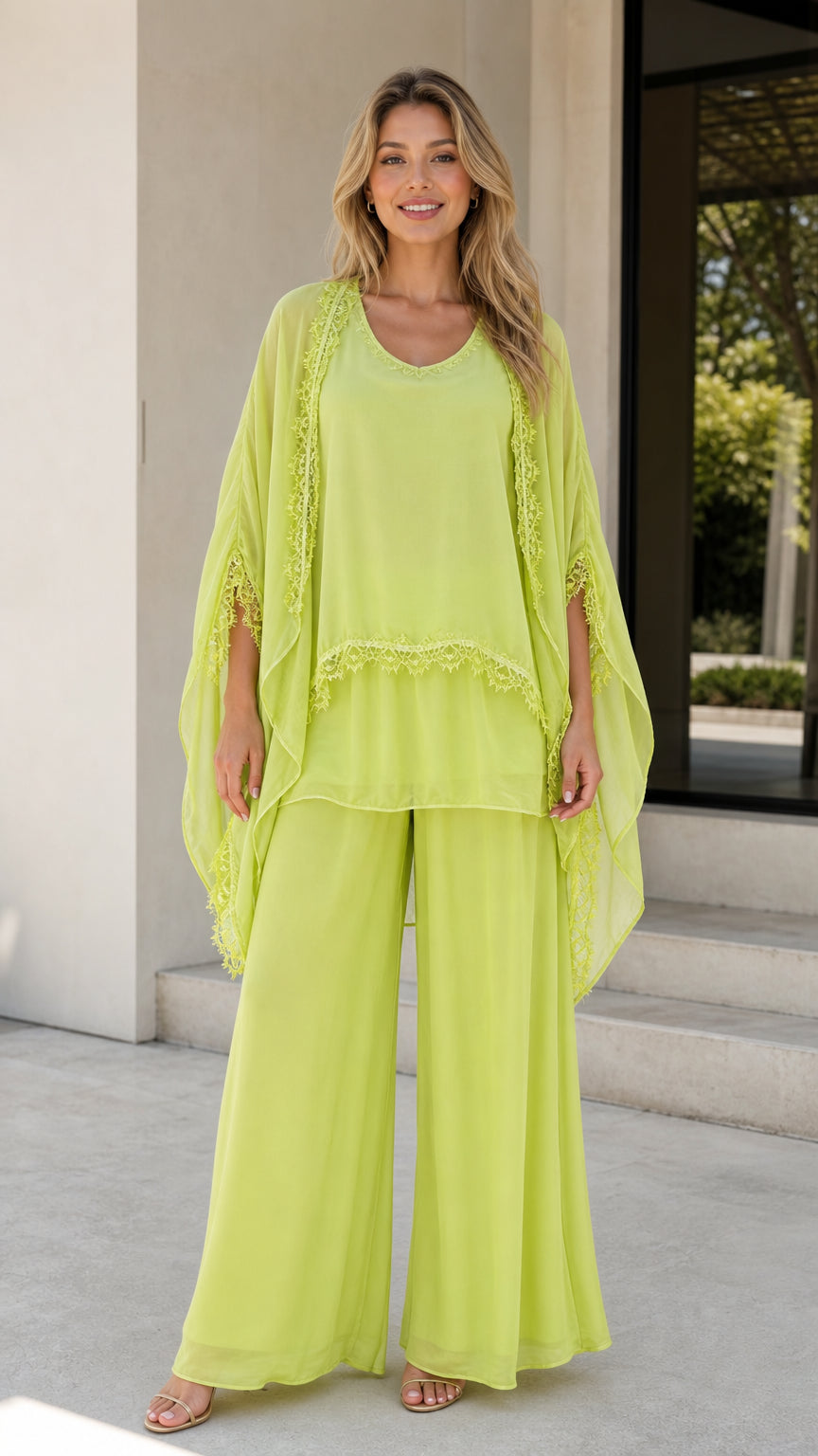 Model wearing lime green chiffon 3-piece pants set with cape