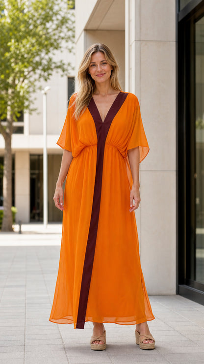 Front view of model wearing orange maxi kaftan dress with contrast brown panel