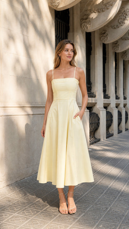 Front full view of woman wearing yellow square neck midi dress