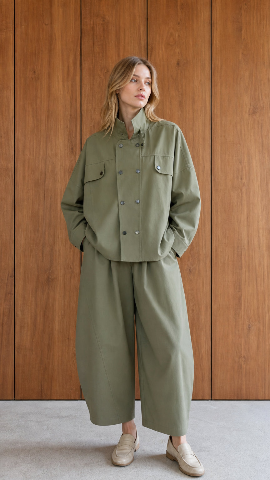 Front view of woman wearing sage green utility jacket and wide-leg pants set