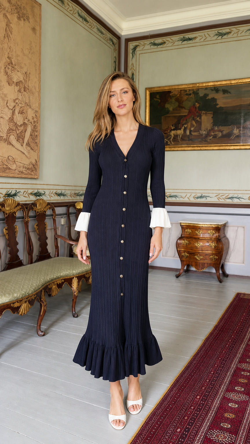 Front view of model wearing navy blue ribbed knit midi dress with white cuffs