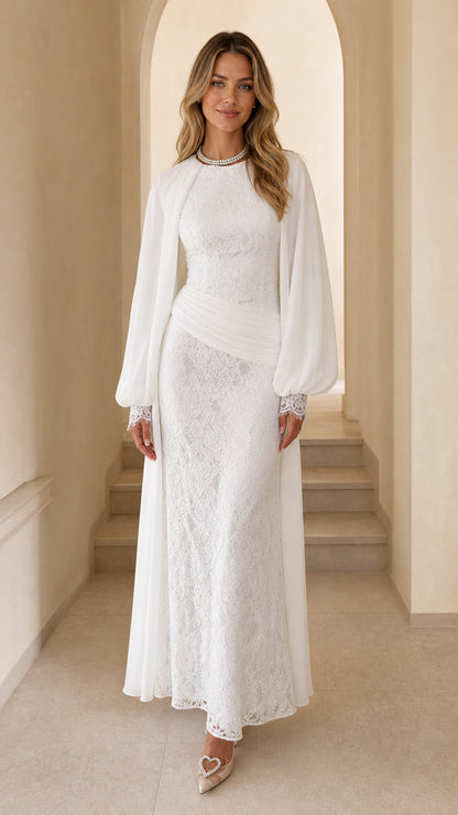 Front view of woman wearing white long sleeve lace maxi dress