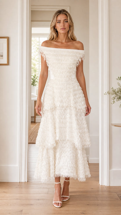 Front view of woman wearing white off-the-shoulder tiered fringe midi dress