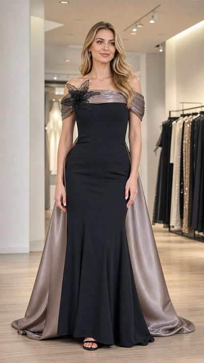 Front view of black off-shoulder evening gown with cape