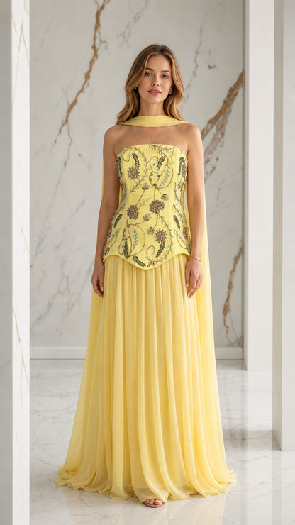 Front view of yellow strapless embroidered chiffon evening gown with neck scarf