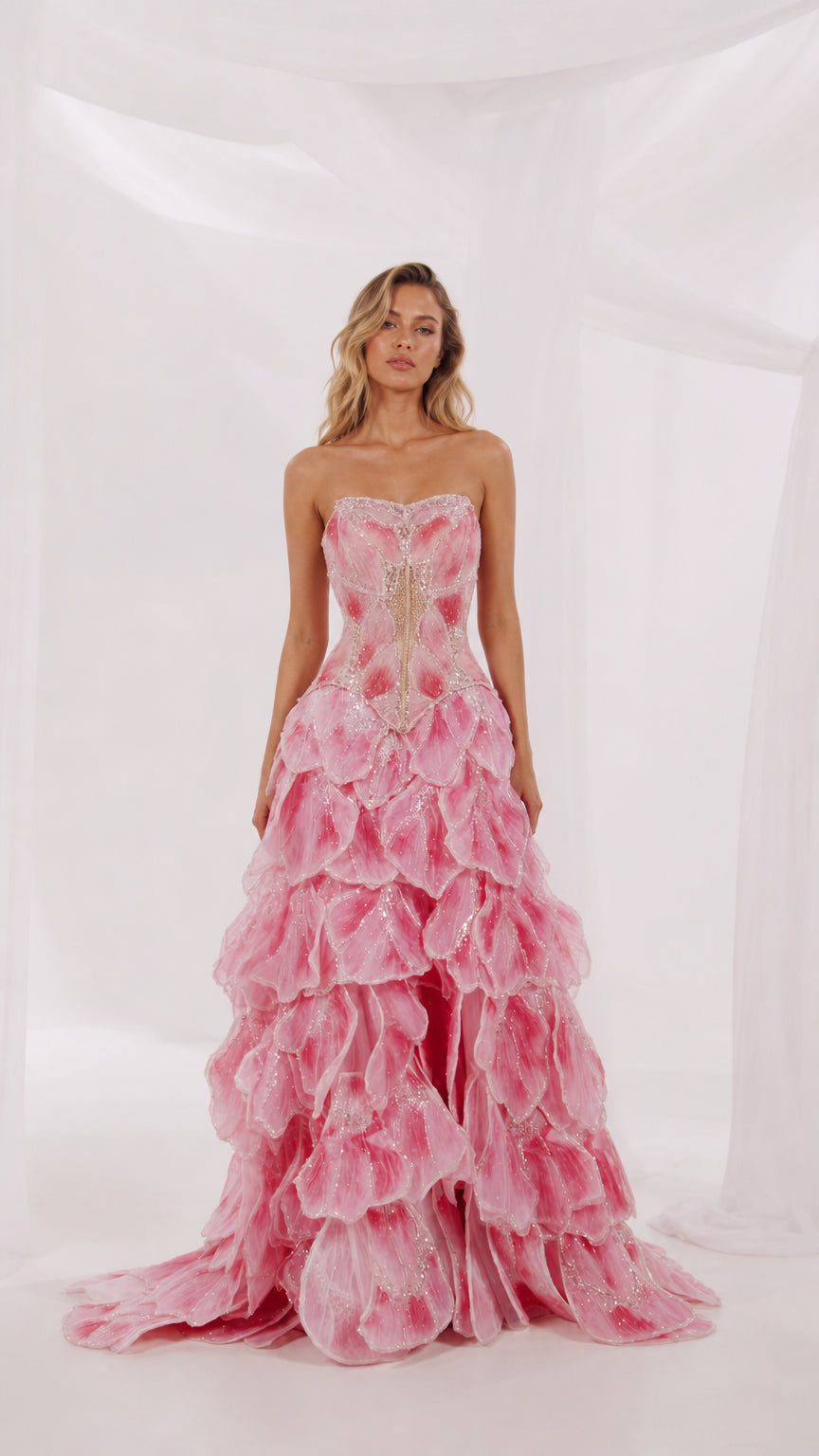 Front view of pink strapless floral applique tiered evening gown