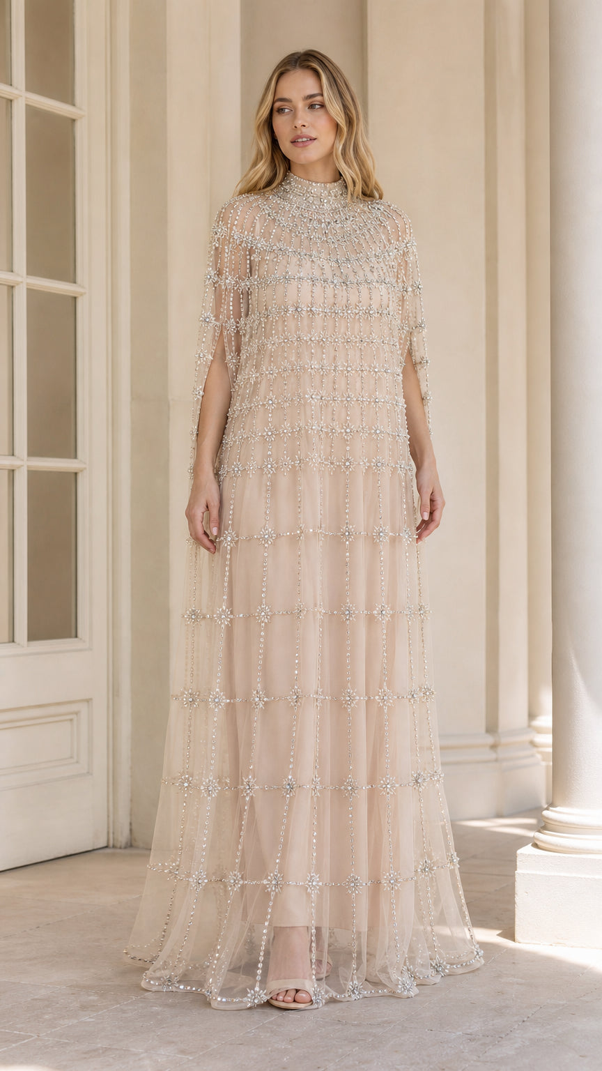 Front view of champagne high neck crystal embellished cape evening gown