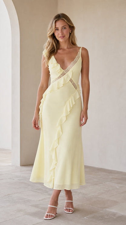 Model wearing yellow ruffled lace-trim slip midi dress, front view