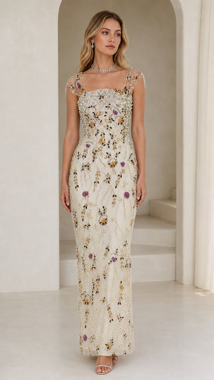 Front view of model wearing champagne embellished floral beaded evening gown
