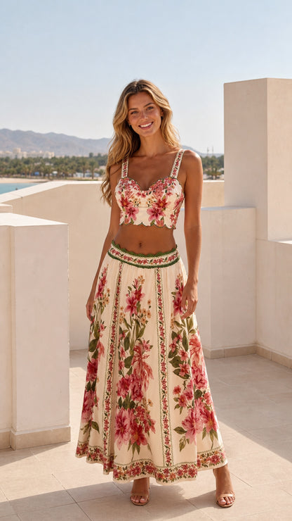 Model wearing ivory floral two-piece crop top and maxi skirt set