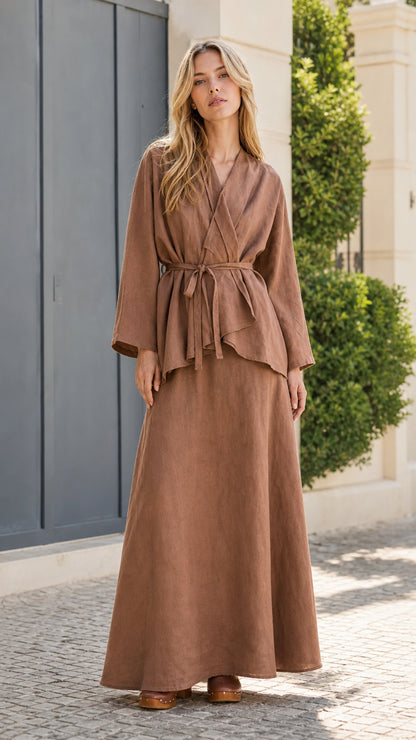 Front view of model wearing brown two-piece wrap top and maxi skirt set