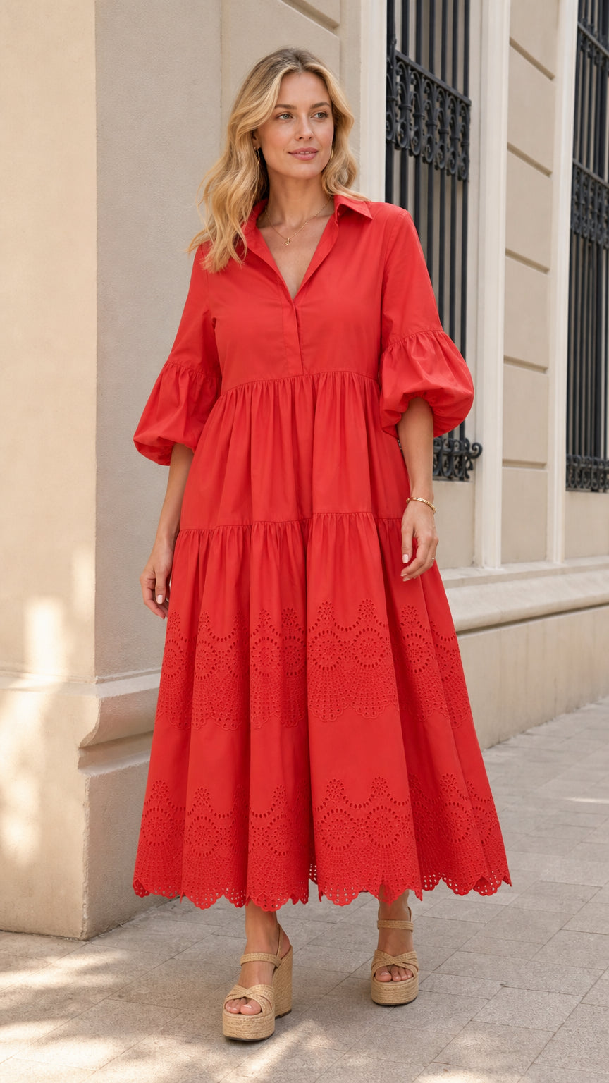 Front view of woman wearing red collared tiered midi dress with puff sleeves