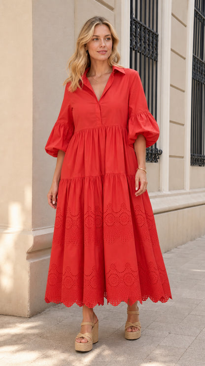 Front view of woman wearing red collared tiered midi dress with puff sleeves