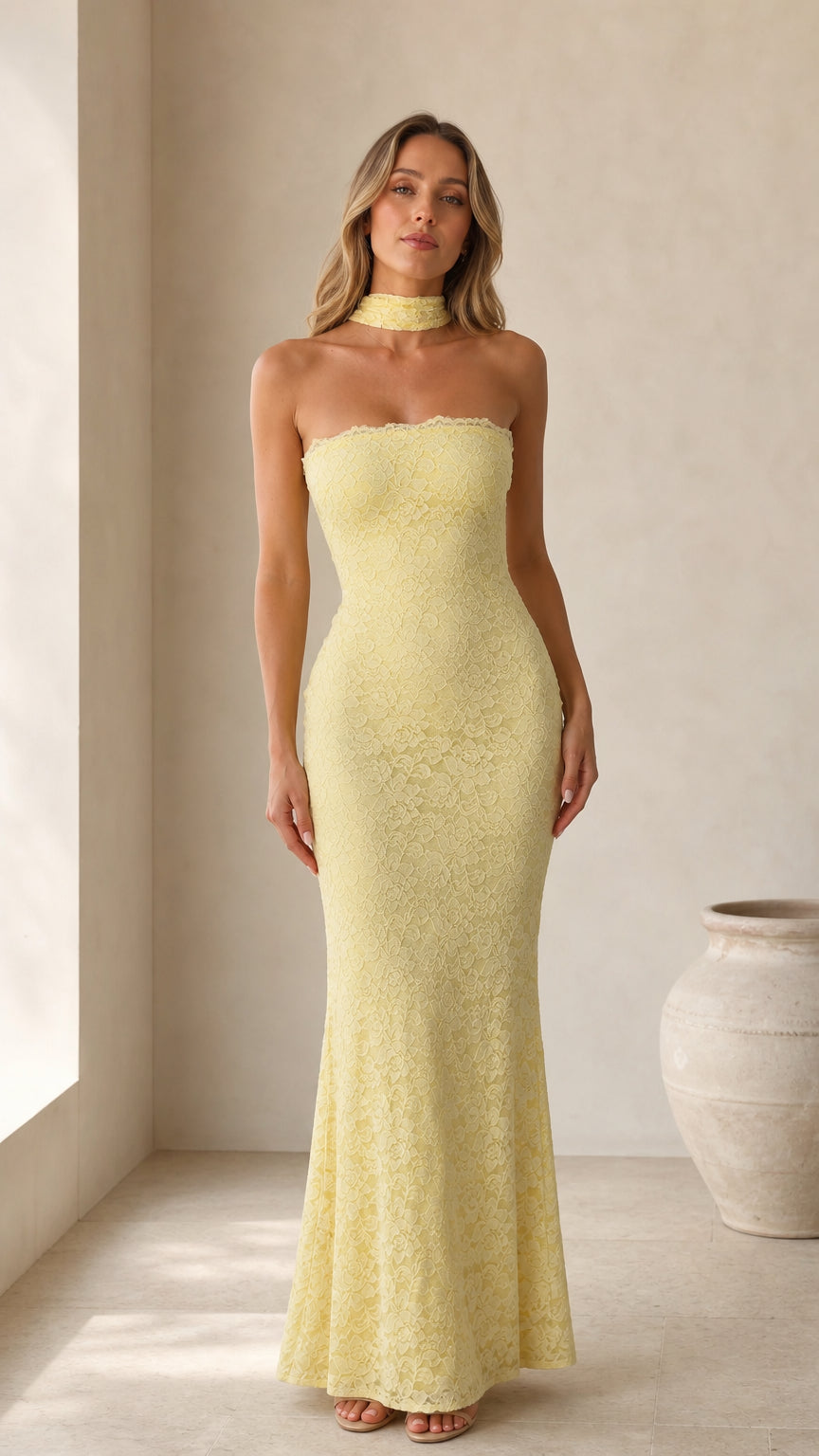 Front view of model wearing yellow strapless lace maxi dress with choker