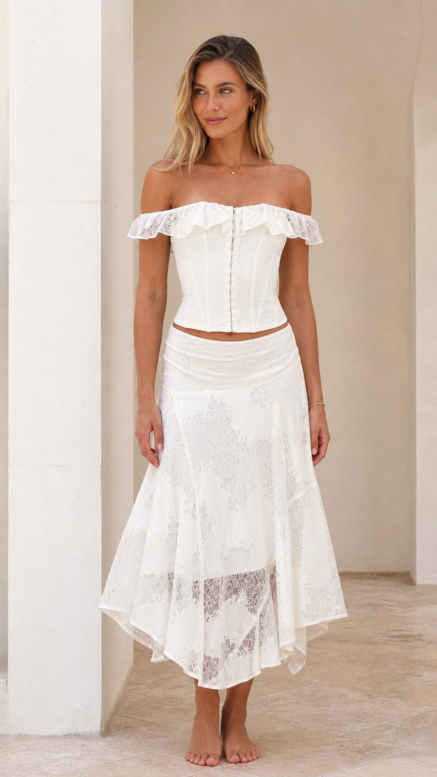Woman wearing white off-shoulder lace corset top and asymmetrical midi skirt front view