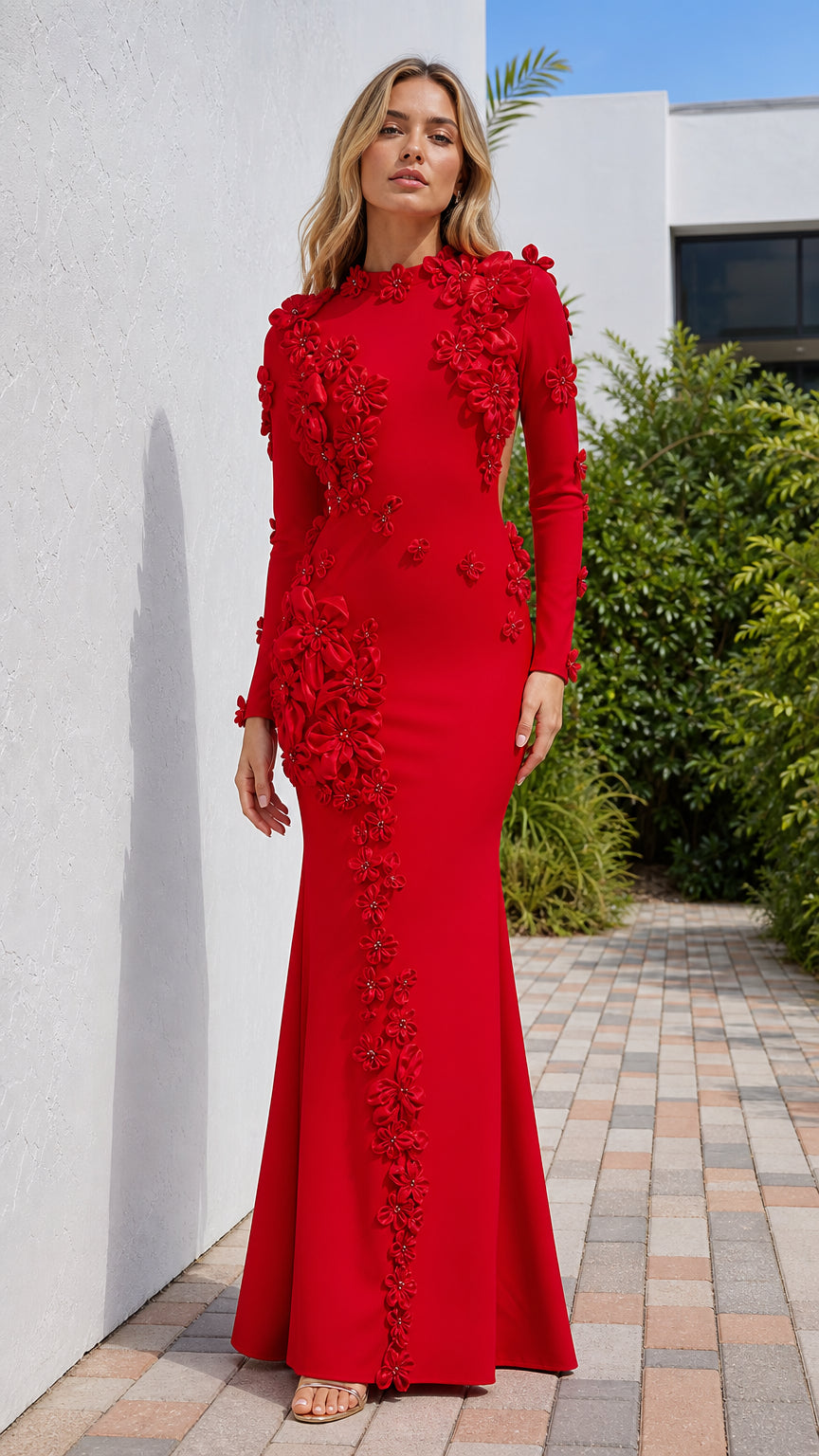 Front view of model wearing red long sleeve evening gown with 3D floral appliques