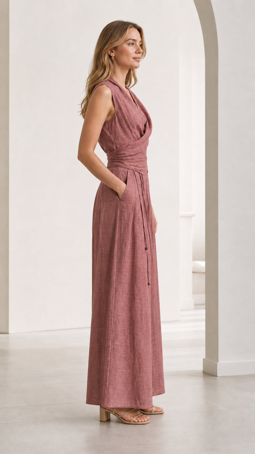 Side profile of woman wearing Dusty Rose sleeveless wide-leg jumpsuit with pockets