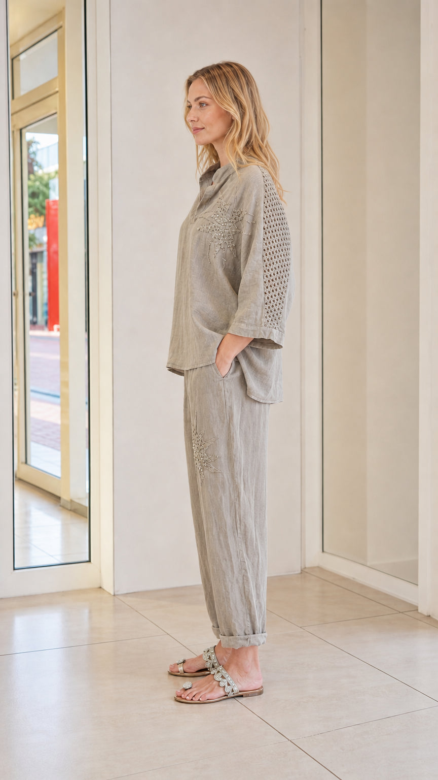Side view of model wearing taupe two-piece set with sleeve detail