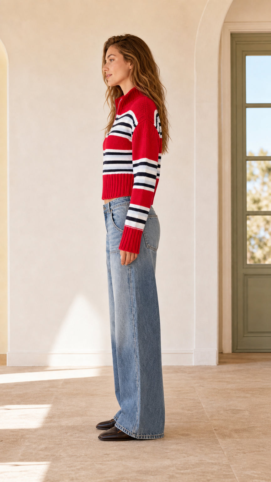 Side view of woman in red striped half-zip cropped knit pullover