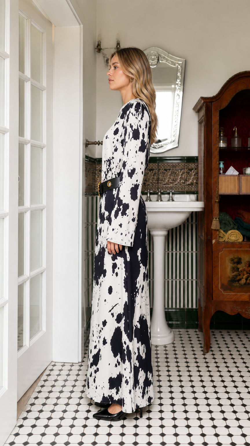 Side profile of woman wearing white cow print maxi dress