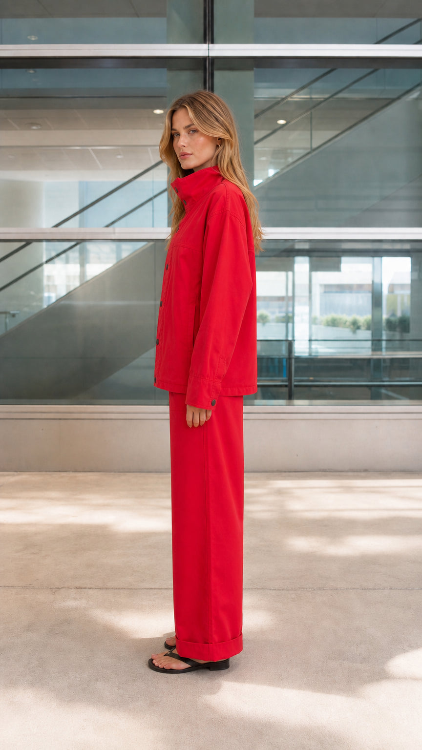 Side profile view of red utility jacket and wide-leg cuffed trousers