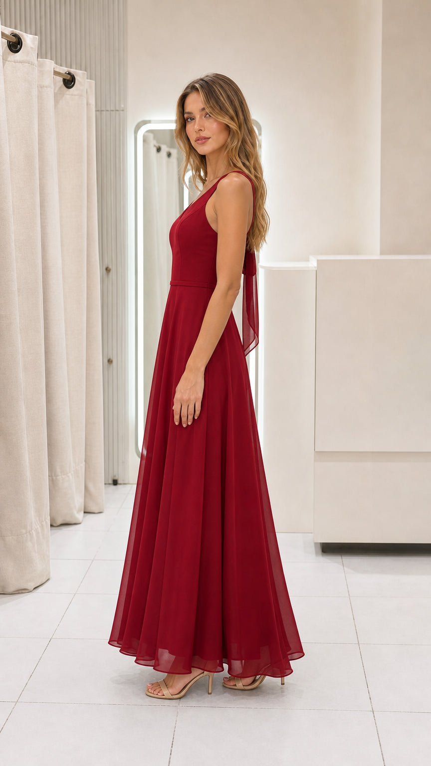 Model wearing burgundy chiffon maxi dress side view