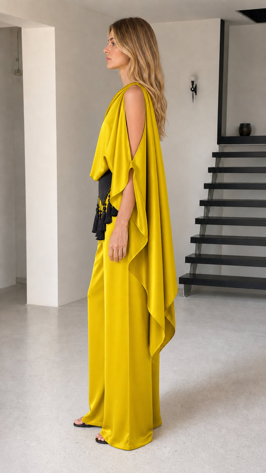 Side profile view of yellow draped cape sleeve two-piece pant set
