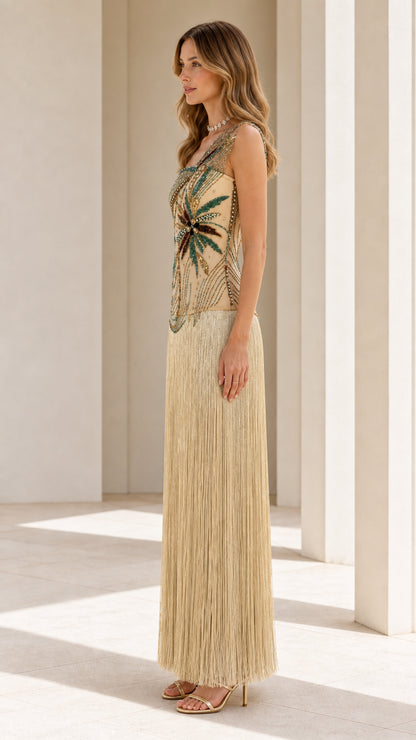 Side profile view of model in gold beaded fringe gown