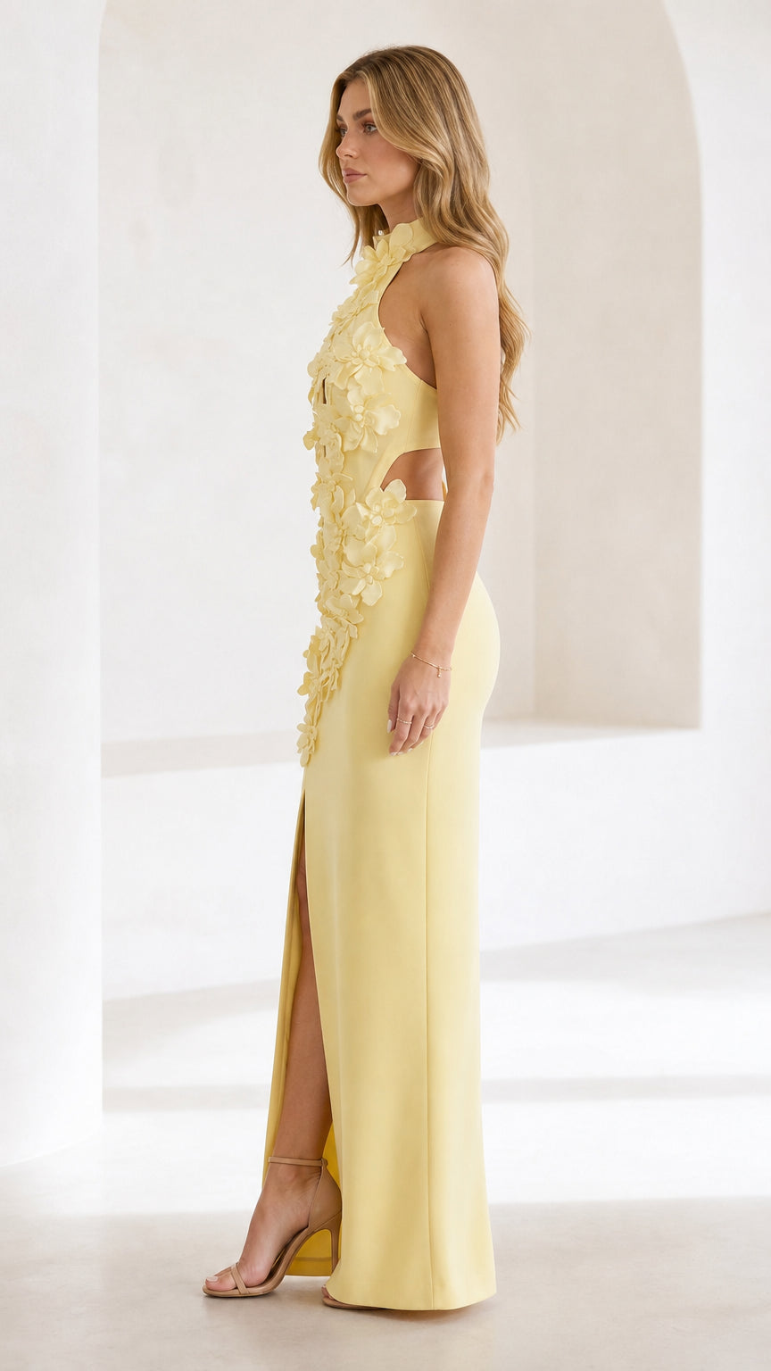 Side profile view of yellow formal gown with high slit