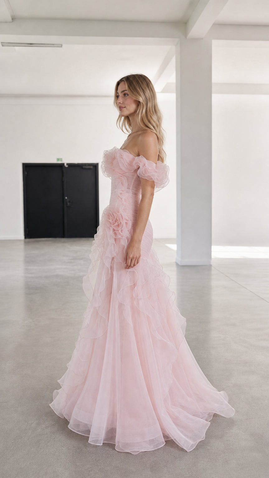 Side profile view of pink tulle evening gown with cascading ruffles