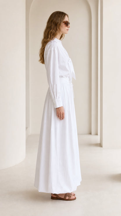Woman wearing white two-piece set, side profile