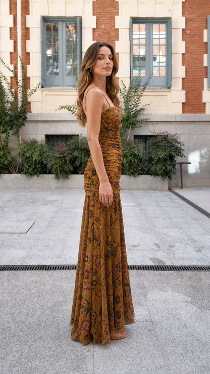 Side profile view of mustard floral ruched maxi dress