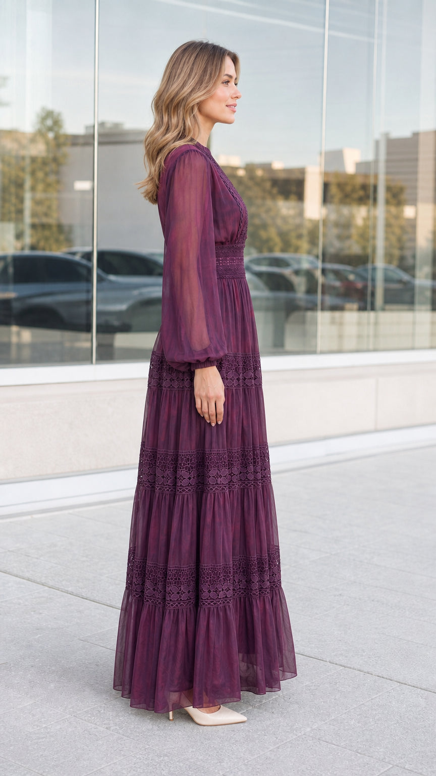 Side full-length view of woman wearing plum tiered long sleeve maxi dress