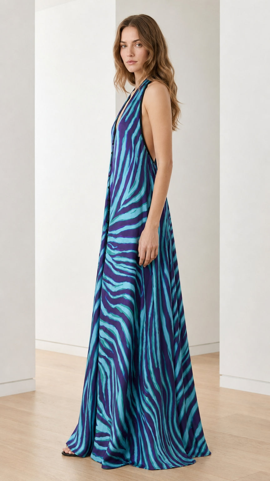 Side profile of woman in blue zebra print maxi dress