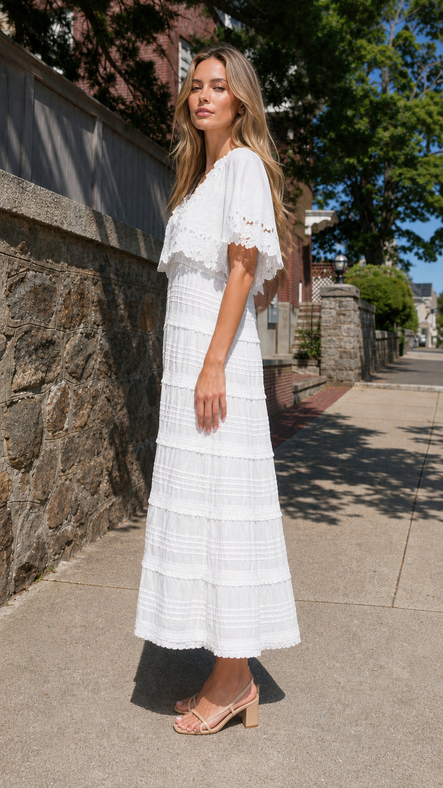 Side profile view of woman in white tiered maxi dress