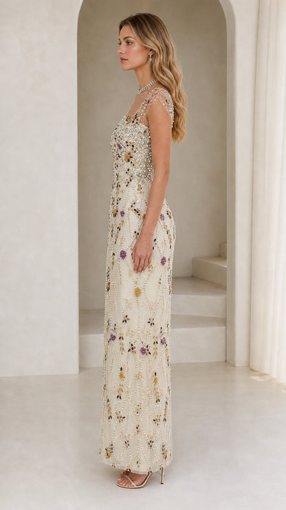 Side profile view of model in champagne beaded evening gown