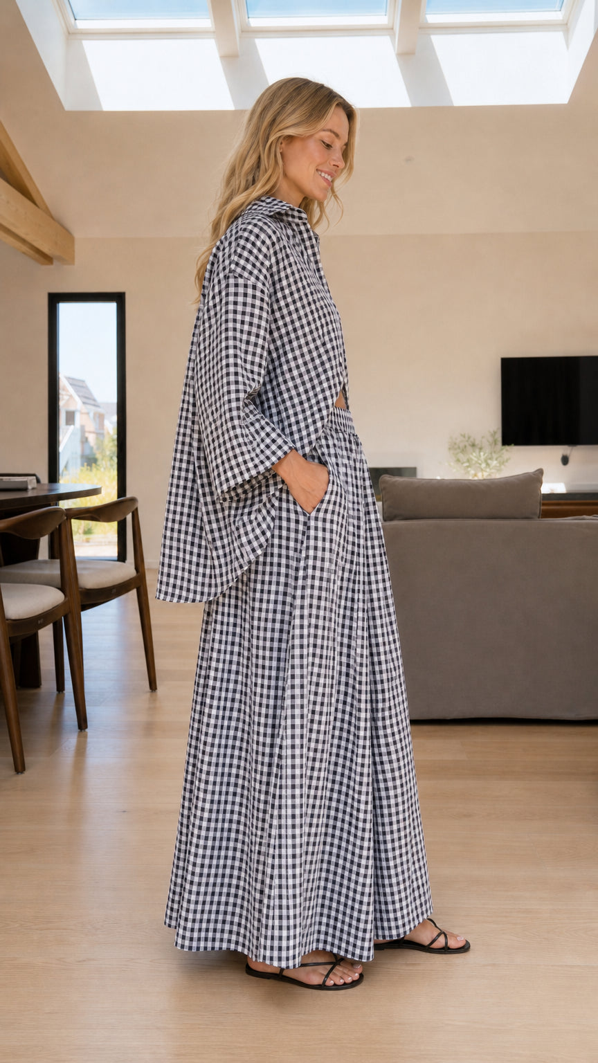 Side profile of woman in black and white gingham two-piece set