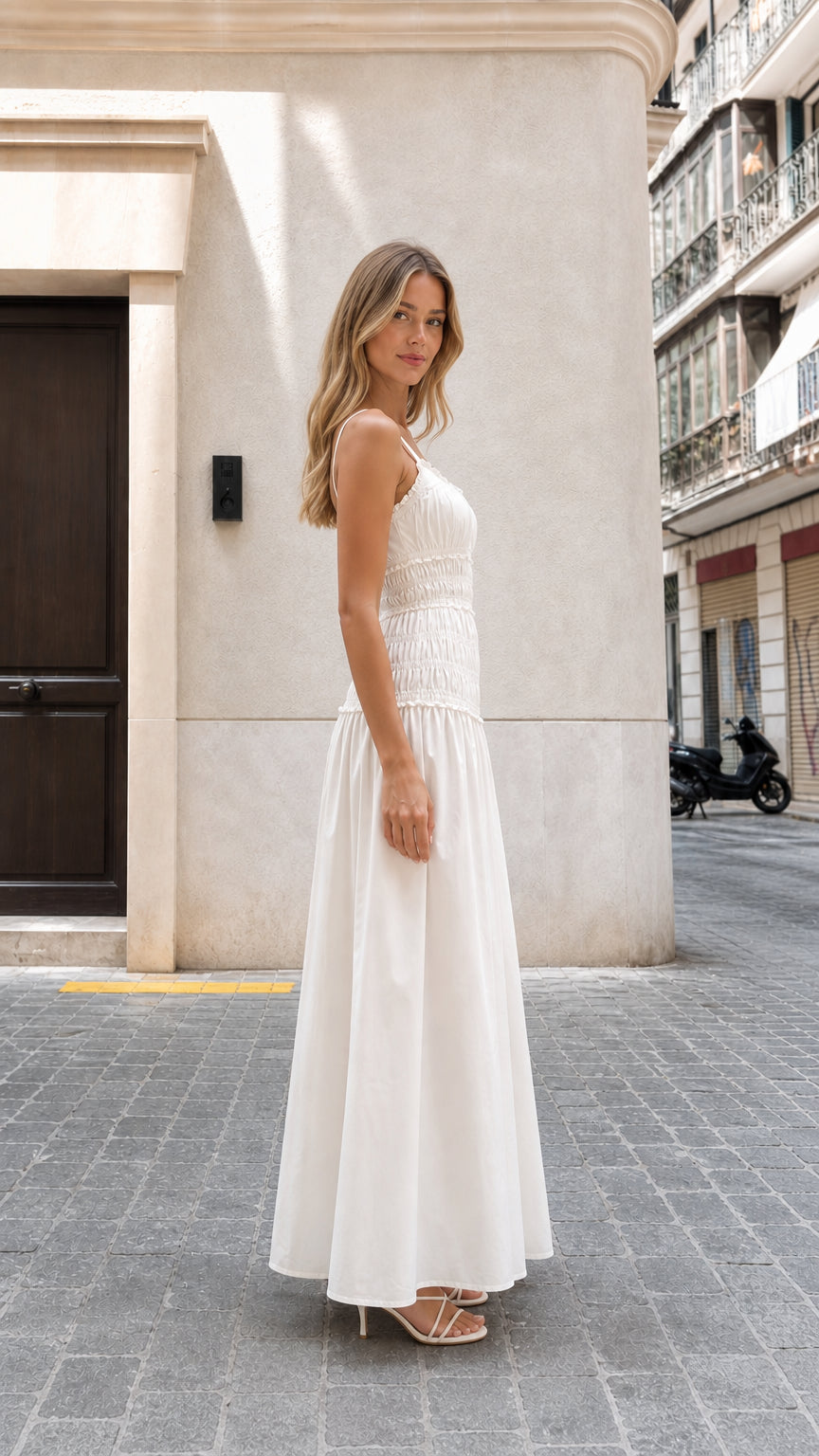 Model wearing white smocked maxi dress side profile view
