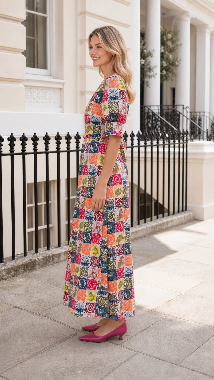 Side view of woman wearing multi-color patchwork midi dress outdoors