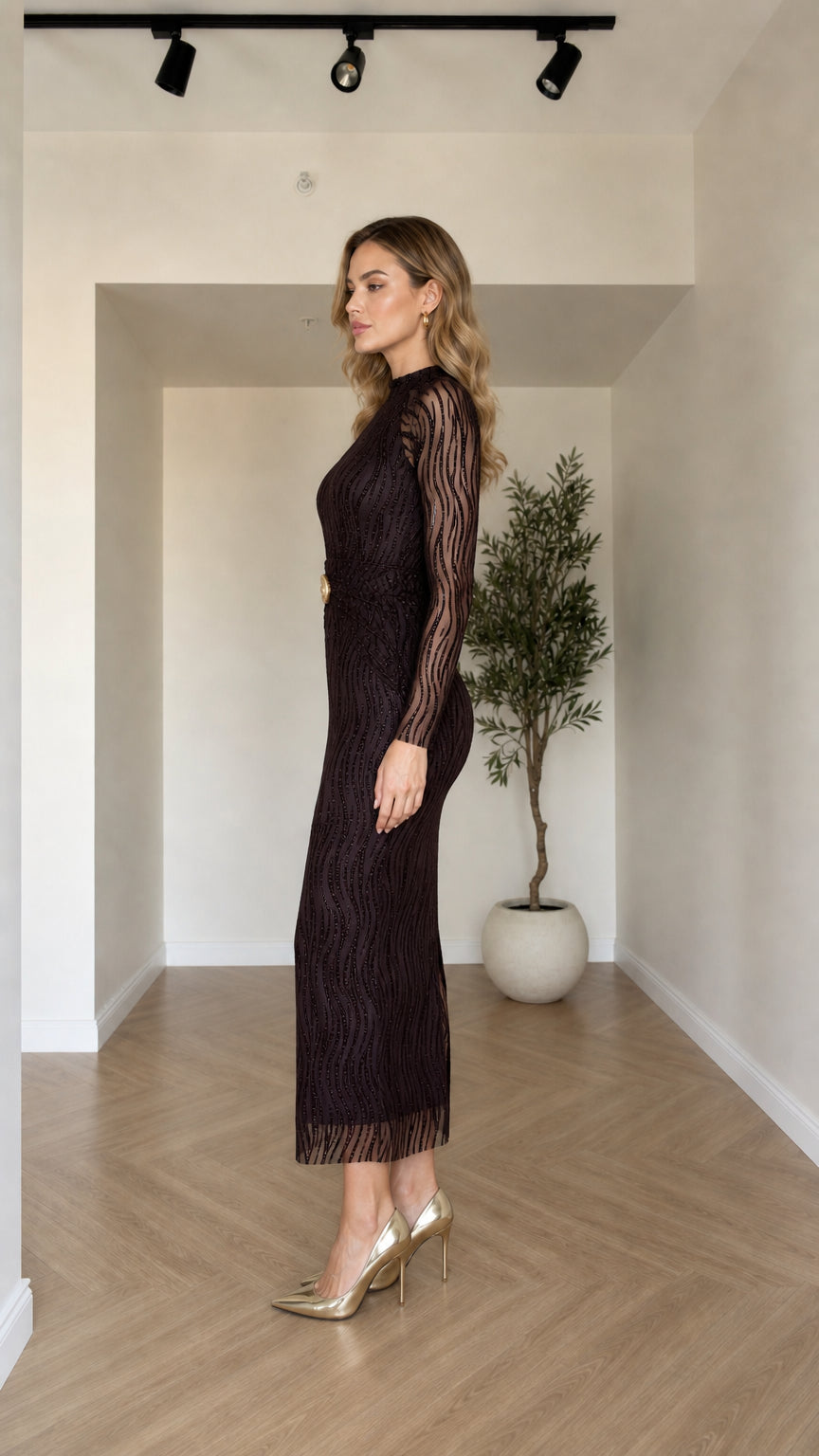 Side profile view of model in the Dark Plum textured long sleeve midi dress