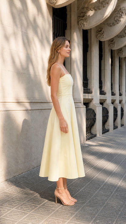 Side profile view of woman in yellow A-line midi dress