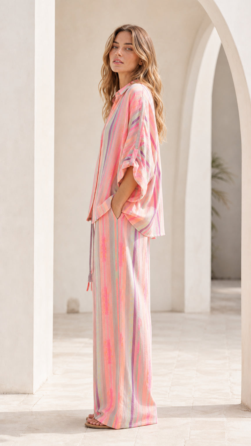 Side view of model wearing pink striped lounge set