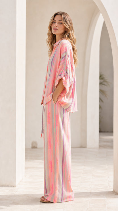 Side view of model wearing pink striped lounge set