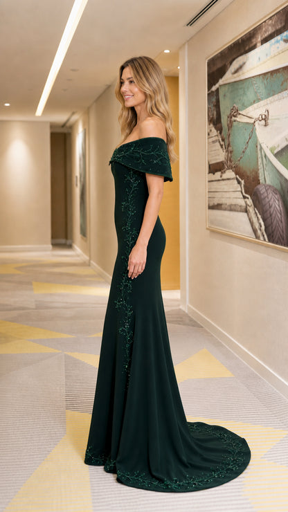 Side profile of dark green mermaid gown with train