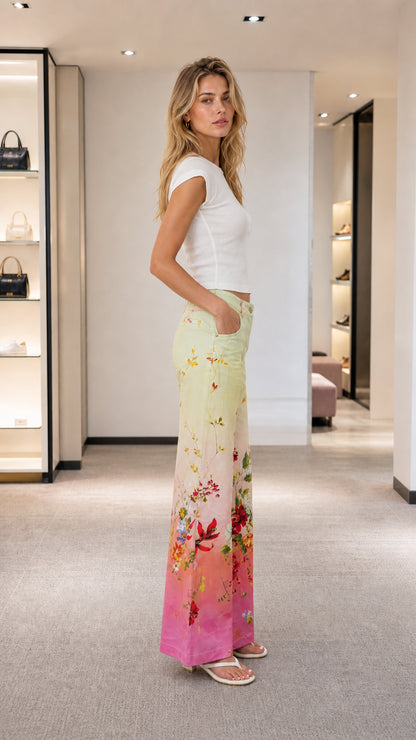 Side profile of model wearing floral ombre wide leg pants with white crop top