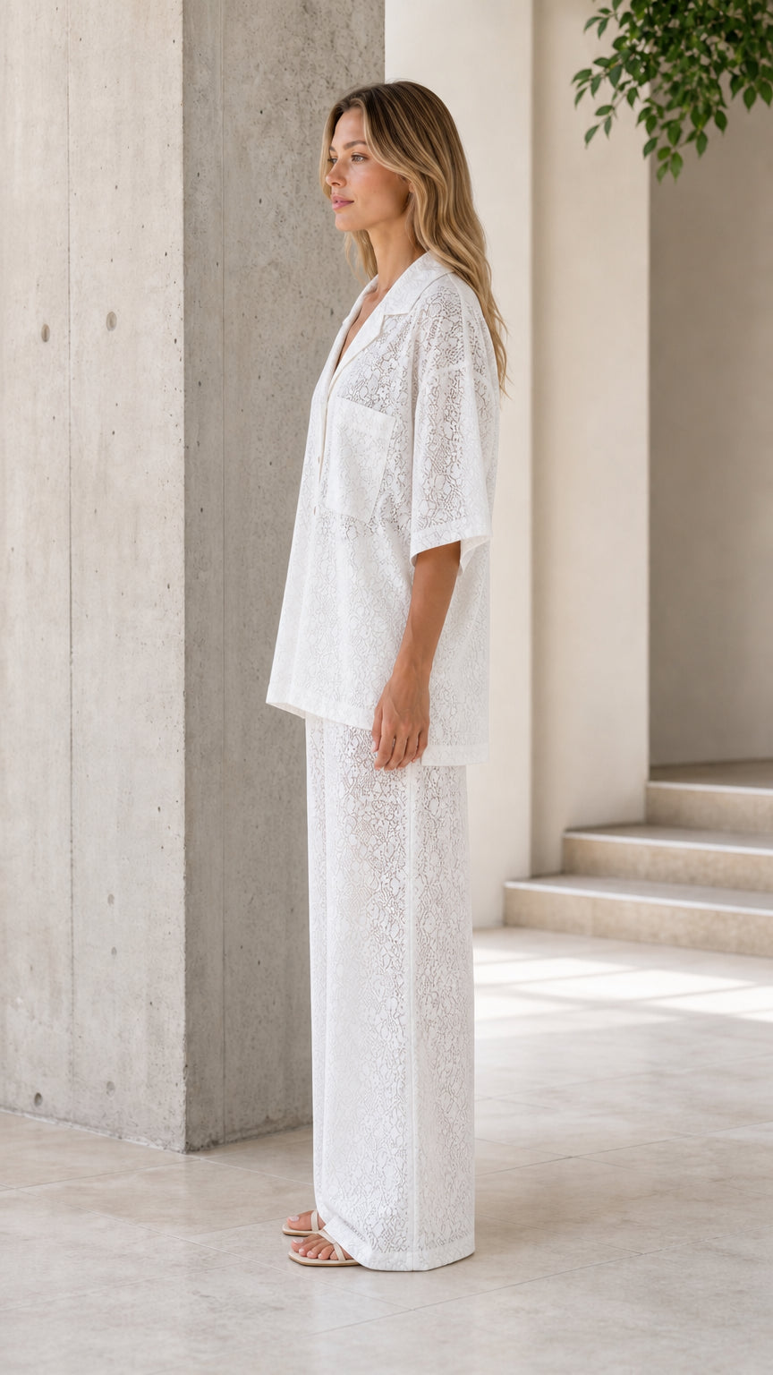 Side view of woman wearing white lace two-piece set