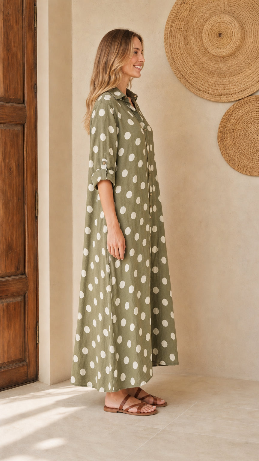 Side view of woman wearing olive polka dot maxi shirt dress