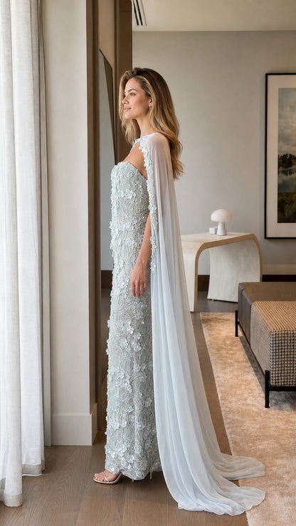 Side profile of Ice Blue floral beaded evening dress showing floor-length cape silhouette