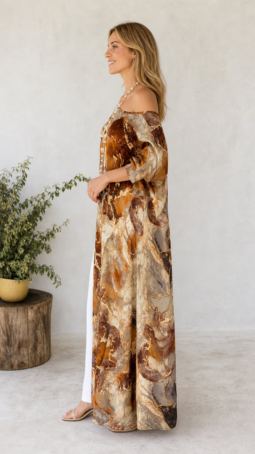 Side profile of model wearing brown marble print maxi tunic